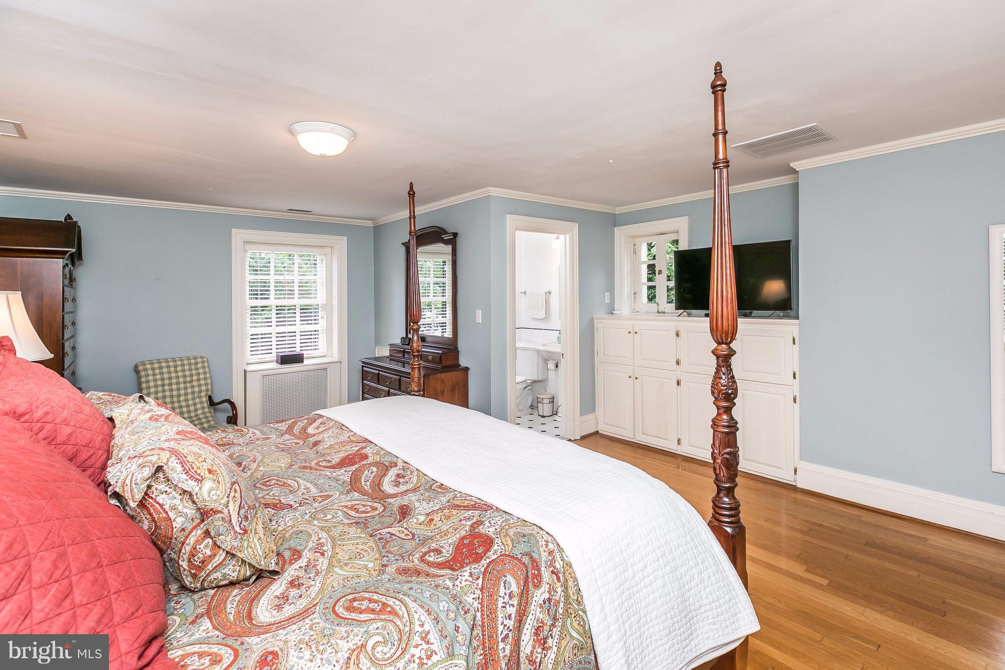 6306 Blenheim Road Baltimore, MD 21212 - Photo 17 of 30 a bedroom with a bed and a flat screen tv