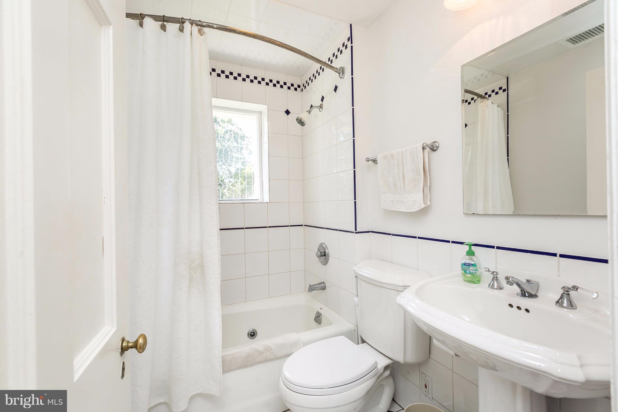 6306 Blenheim Road Baltimore, MD 21212 - Photo 18 of 30 a bathroom with a sink a toilet and shower