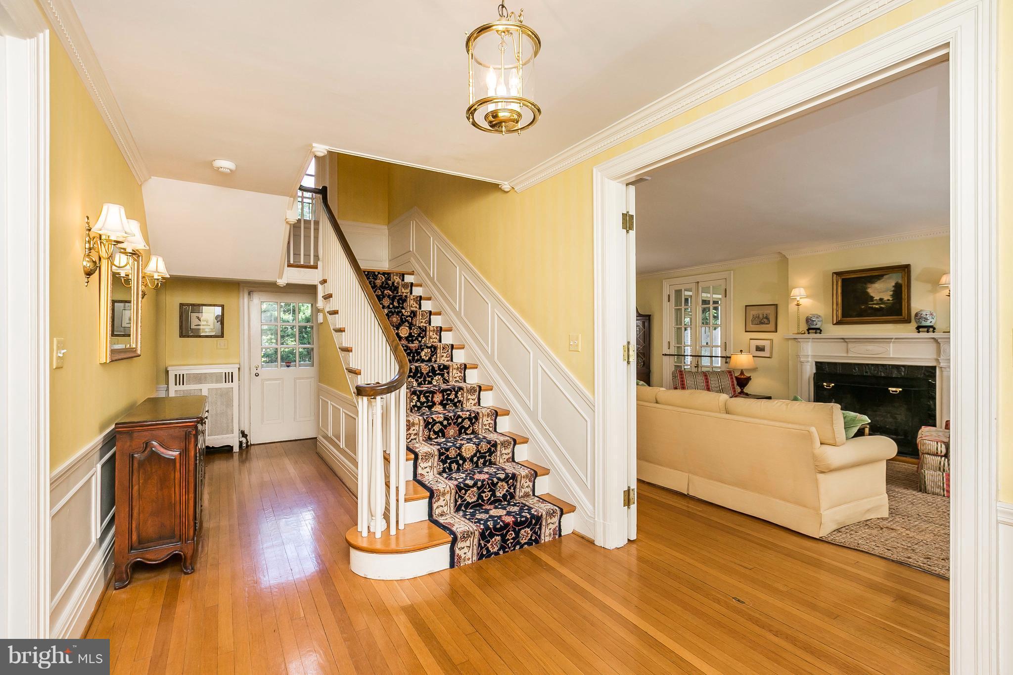 6306 Blenheim Road Baltimore, MD 21212 - Photo 3 of 30 a view of a livingroom with furniture wooden floor a ceiling fan and windows