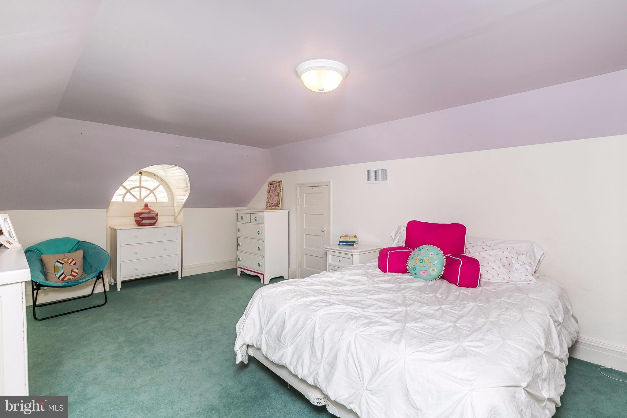 6306 Blenheim Road Baltimore, MD 21212 - Photo 22 of 30 a bedroom with a bed and a chandelier