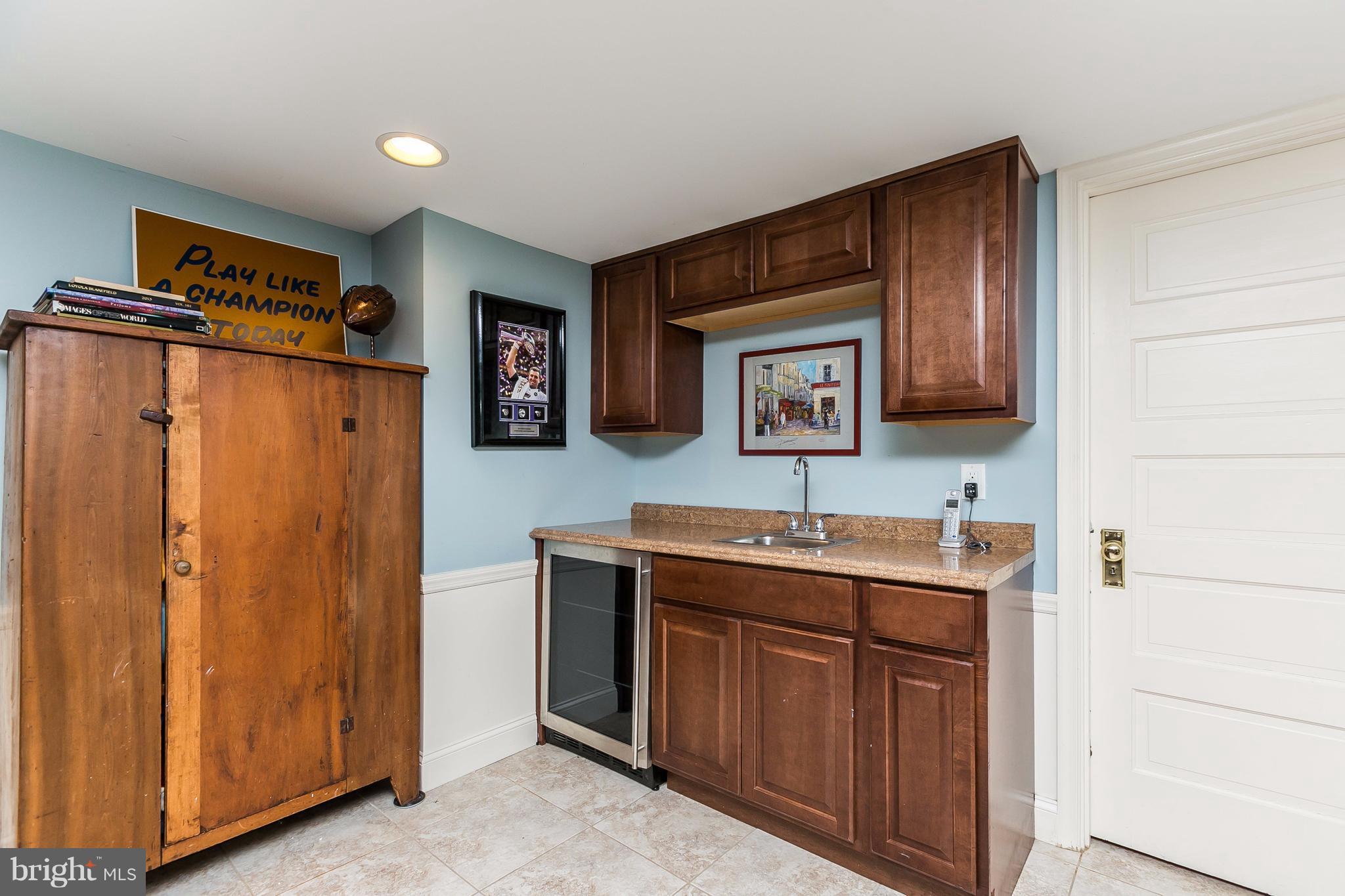 6306 Blenheim Road Baltimore, MD 21212 - Photo 24 of 30 a hall with cabinets and a wooden floor