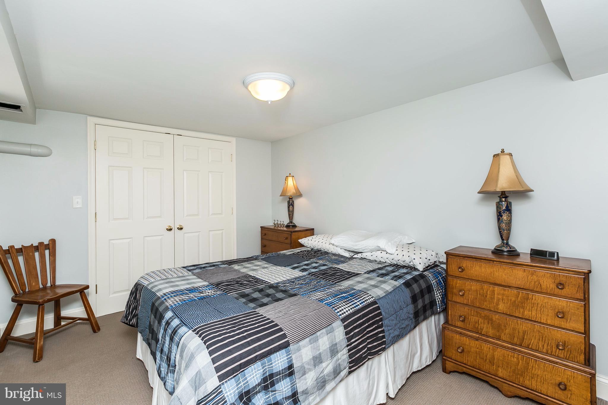 6306 Blenheim Road Baltimore, MD 21212 - Photo 25 of 30 a bedroom with a bed and a lamp on table