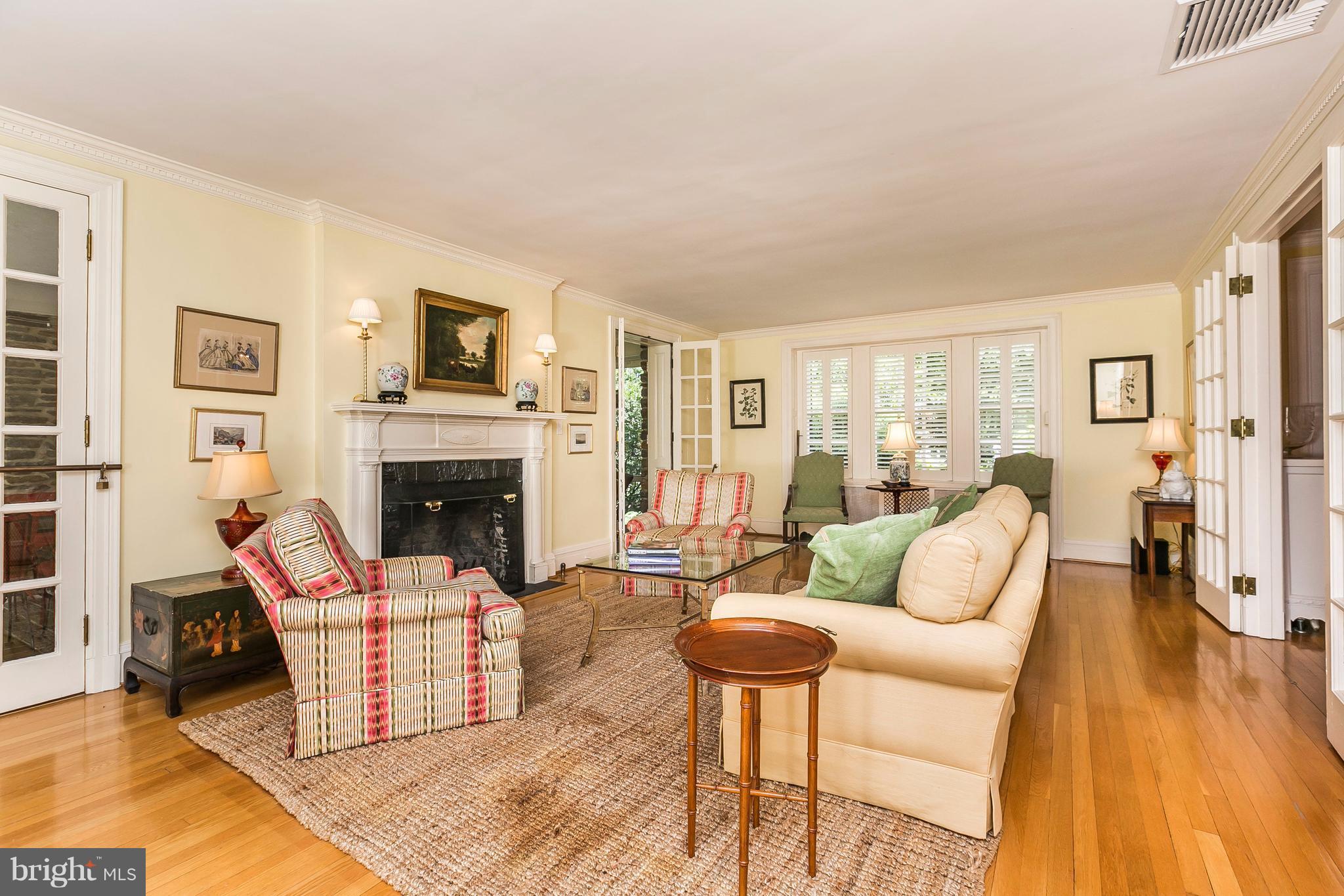 6306 Blenheim Road Baltimore, MD 21212 - Photo 4 of 30 a living room with furniture a fireplace and a table