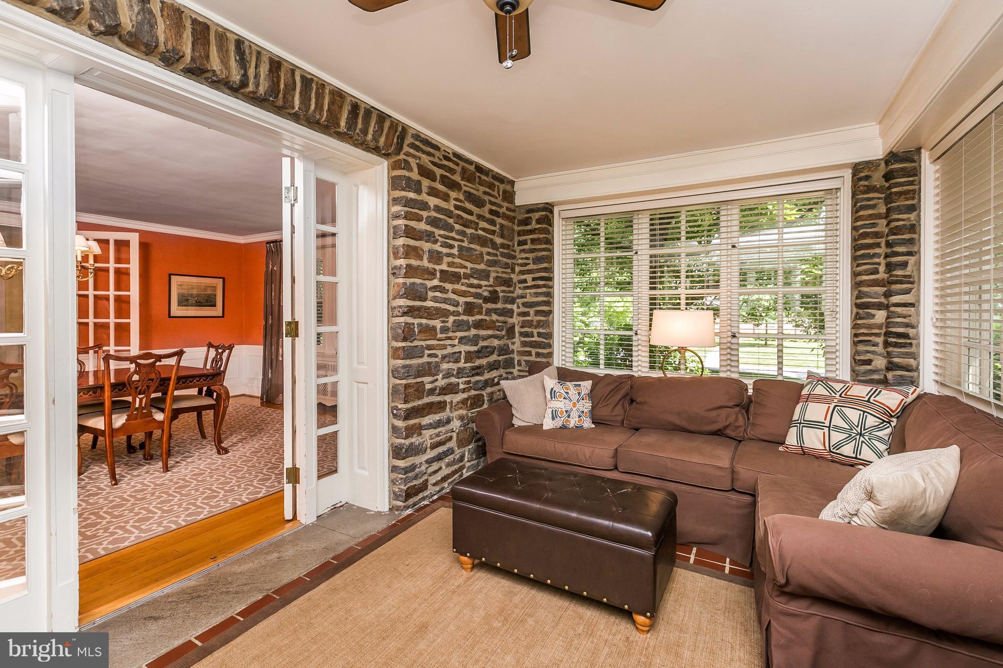 6306 Blenheim Road Baltimore, MD 21212 - Photo 9 of 30 a living room with furniture and a floor to ceiling window