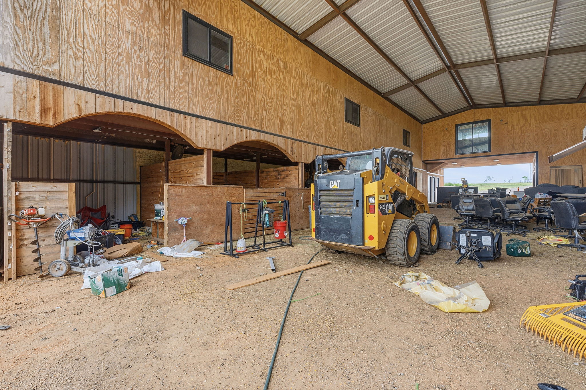1701 County Road 466 Elgin, TX 78621 - Photo 14 of 24 A spacious barn interior with wooden walls and stalls awaits its next purpose.