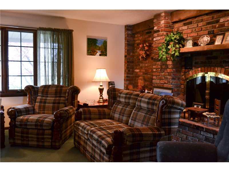 261 Darr Road Belle Vernon, PA 15012 - Photo 12 of 25 Living Room. The Wall Brick Fireplace brings charm to this room.