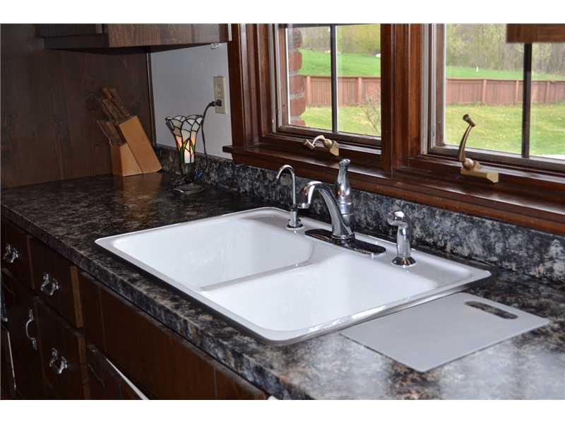 261 Darr Road Belle Vernon, PA 15012 - Photo 6 of 25 Kitchen. Updated Counter tops and newly re-glazed sink showcase the beautiful wooden windows overlooking pool and backyard.