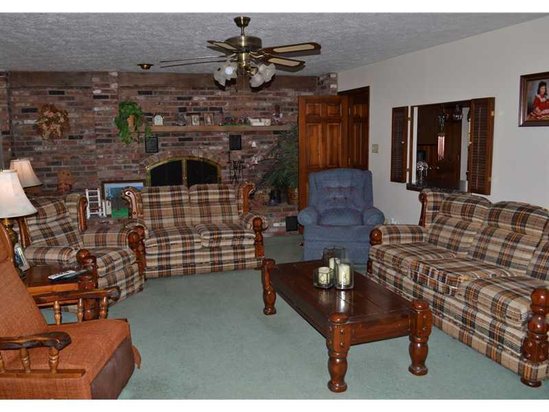 261 Darr Road Belle Vernon, PA 15012 - Photo 9 of 25 Living Room. Very Large Living Room with a Brick Wall Fireplace and wood storage area. Pass through to Kitchen on Right