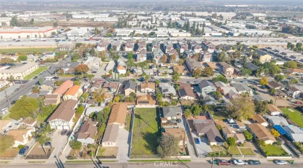 an aerial view of residential houses with city view