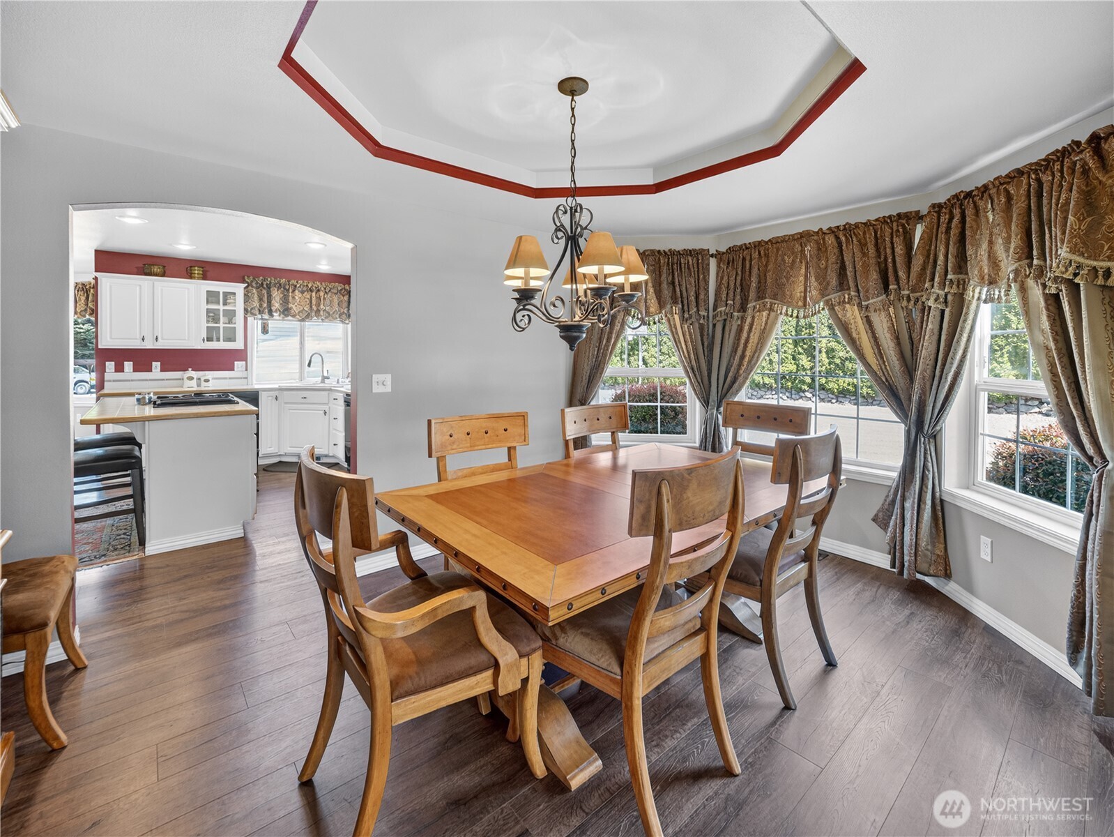 26224 Southeast 425th Street Enumclaw, WA 98022 - Photo 12 of 37 a dining room with wooden floor a chandelier a wooden table and chairs
