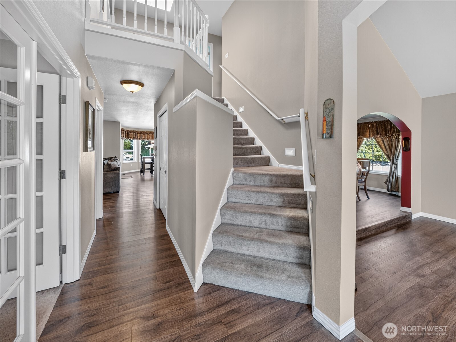 26224 Southeast 425th Street Enumclaw, WA 98022 - Photo 17 of 37 a view of a hallway with wooden floor staircase and windows