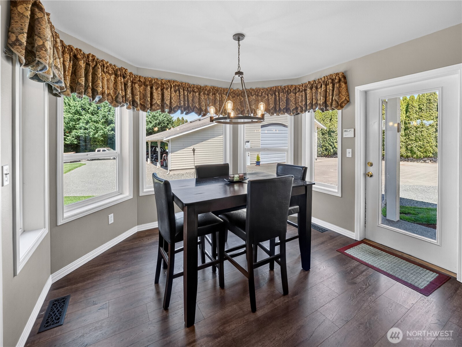 26224 Southeast 425th Street Enumclaw, WA 98022 - Photo 6 of 37 a view of a dining room with furniture window and wooden floor