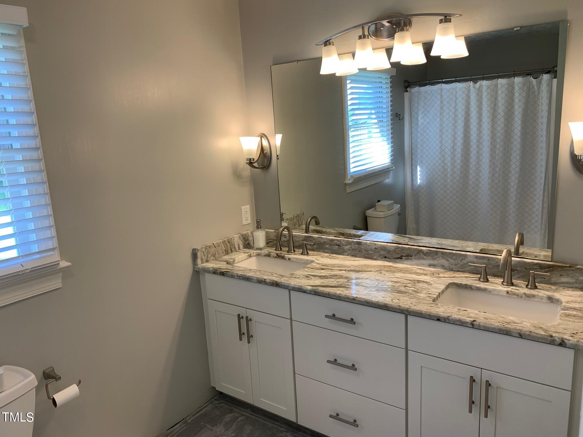 51 Fox Lane Roxboro, NC 27574 - Photo 18 of 25 a bathroom with a granite countertop sink and a mirror
