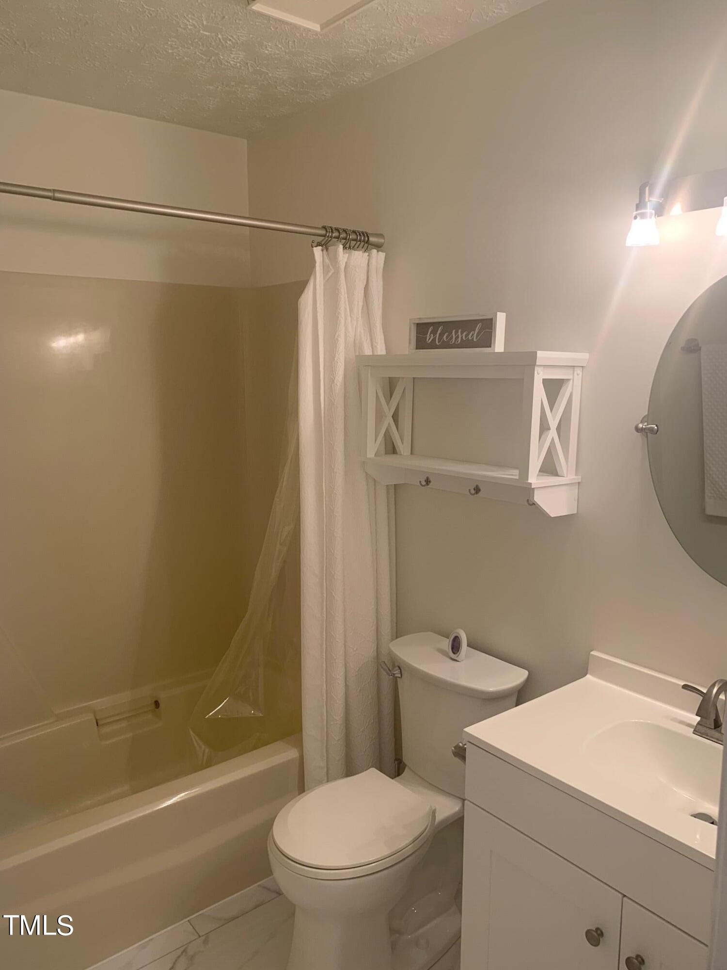 51 Fox Lane Roxboro, NC 27574 - Photo 20 of 25 a bathroom with a sink a toilet and shower
