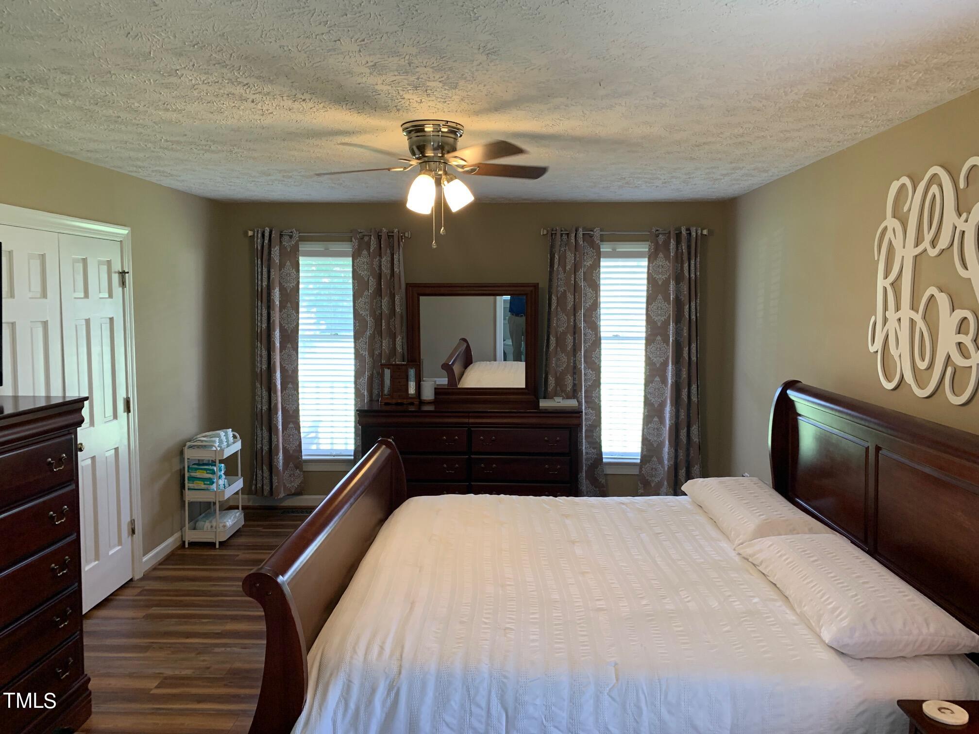 51 Fox Lane Roxboro, NC 27574 - Photo 9 of 25 a bedroom with a large bed and a chandelier