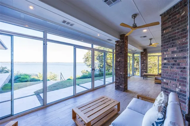 a living room with furniture and a floor to ceiling window