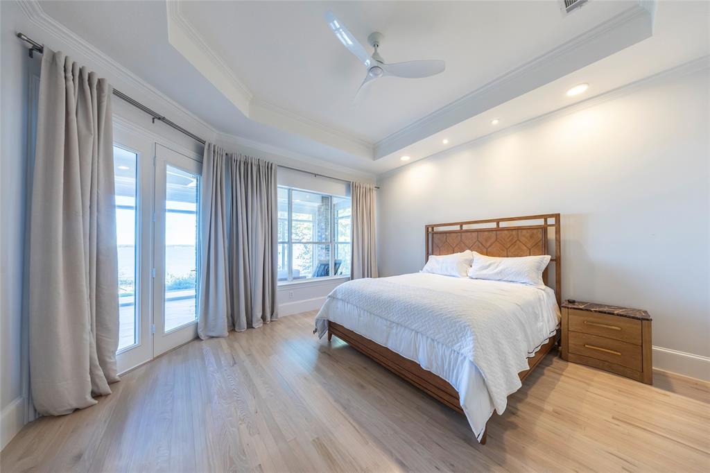 1190 Emerald Sound Boulevard Oak Point, TX 75068 - Photo 17 of 37 a bedroom with a large bed and a large window