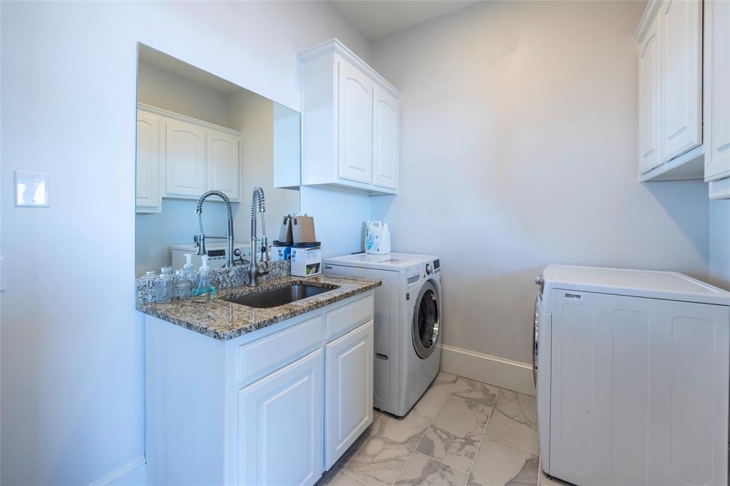 1190 Emerald Sound Boulevard Oak Point, TX 75068 - Photo 22 of 37 a kitchen with a sink stove and cabinets