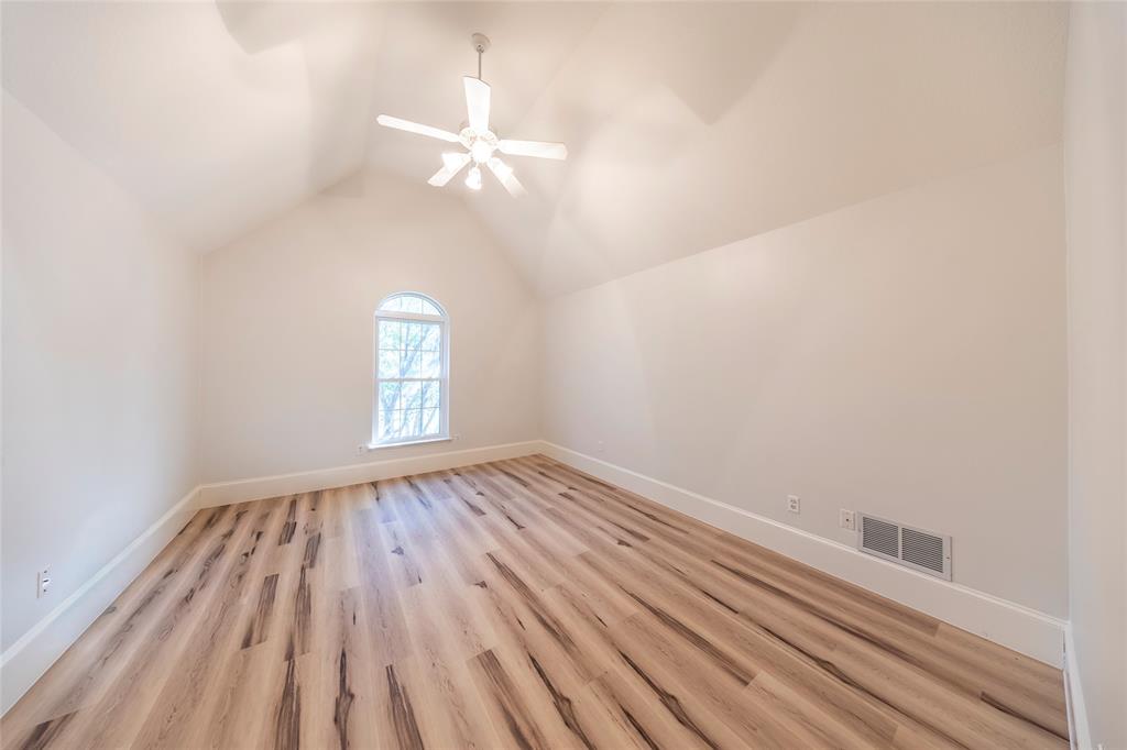 1190 Emerald Sound Boulevard Oak Point, TX 75068 - Photo 25 of 37 an empty room with wooden floor fan and windows