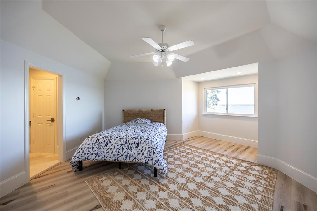 1190 Emerald Sound Boulevard Oak Point, TX 75068 - Photo 27 of 37 a bedroom with a bed and a window