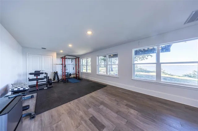 a front view of a house with a yard and trees