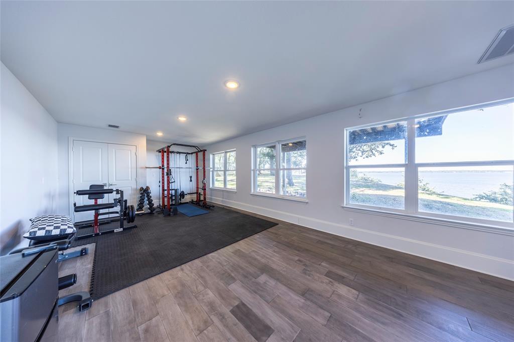 1190 Emerald Sound Boulevard Oak Point, TX 75068 - Photo 29 of 37 a living room with furniture and a large window