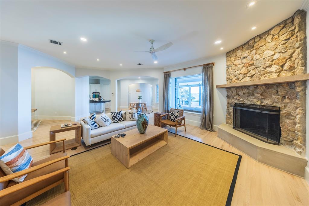 1190 Emerald Sound Boulevard Oak Point, TX 75068 - Photo 7 of 37 a living room with furniture and a fireplace