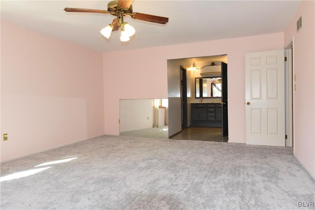 830 Macada Road Bethlehem, PA 18017 - Photo 20 of 35 an empty room with chandelier fan and windows