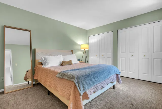 a bedroom with a bed and closet