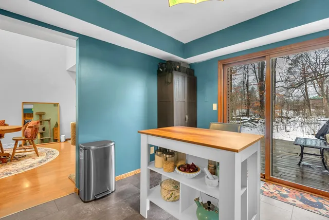 a room with pool table and glass windows