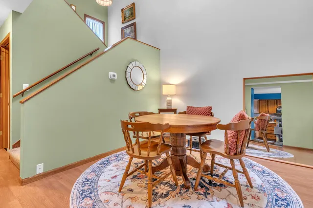 a view of a dining room and hall with wooden floor