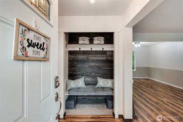 a hallway with a white stove and cabinets