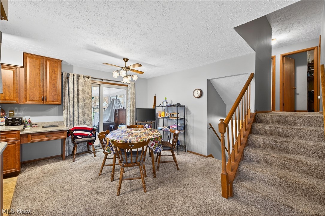 4404 Florida Street Perry, OH 44081 - Photo 5 of 24 Dining space featuring a textured ceiling, light colored carpet, and a ceiling fan
