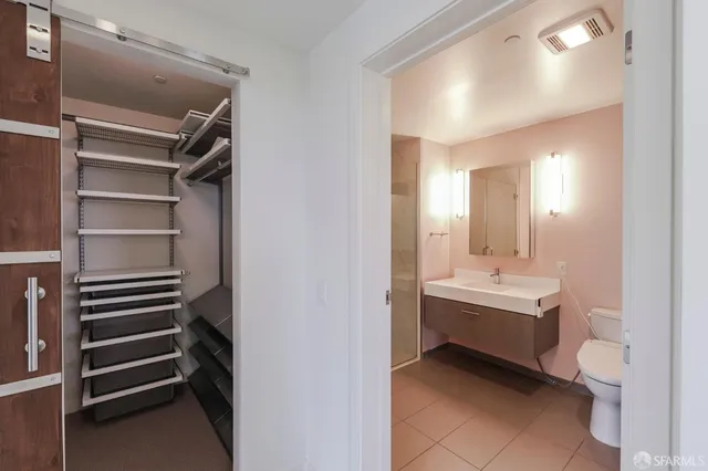a view of bathroom with toilet sink and mirror