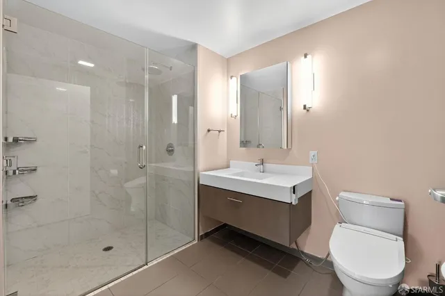 a bathroom with a toilet sink and shower