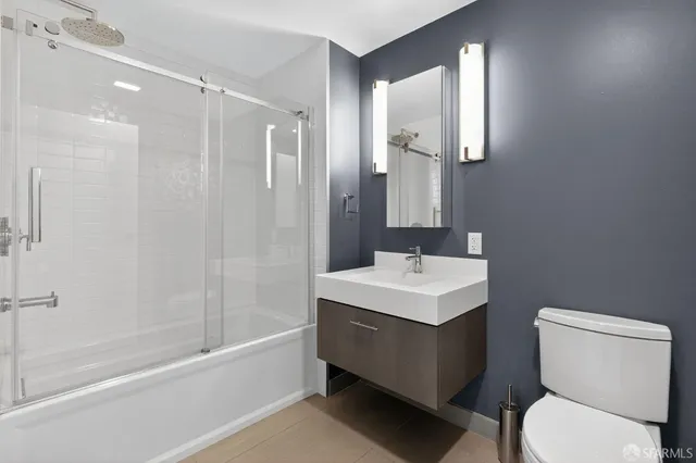 a bathroom with a sink toilet tub and shower