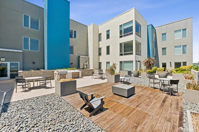 a view of a patio with couches table and chairs and potted plants