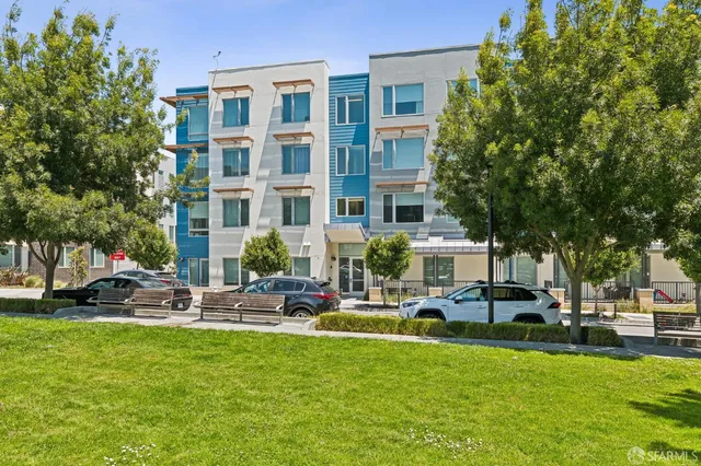 a building with outdoor seating and a garden