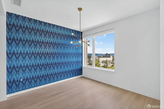 a view of a room with window wooden floor