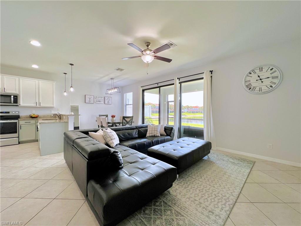 14776 Sutherland Avenue, Unit 416 Naples, FL 34119 - Photo 1 of 50 a living room with couches and kitchen view with wooden floor
