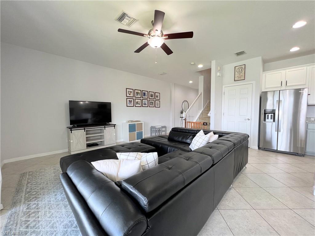 14776 Sutherland Avenue, Unit 416 Naples, FL 34119 - Photo 11 of 50 a living room with furniture and a flat screen tv