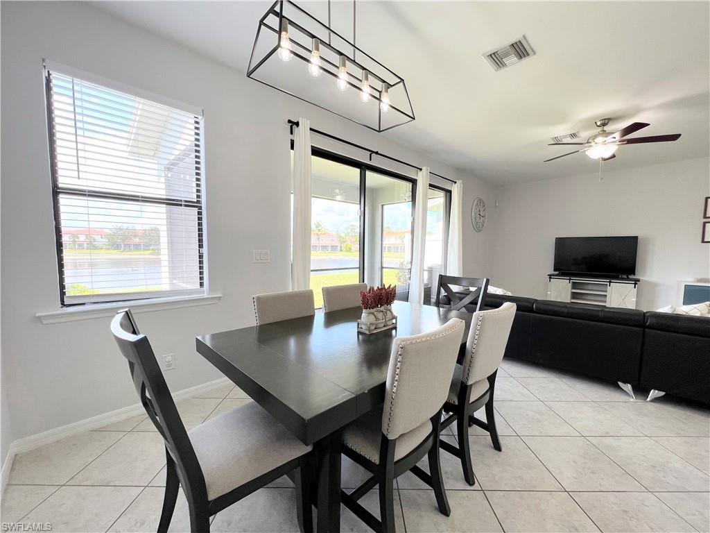 14776 Sutherland Avenue, Unit 416 Naples, FL 34119 - Photo 12 of 50 a view of a dining room with furniture window and outside view