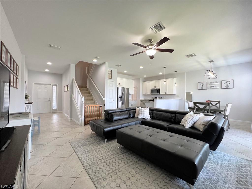 14776 Sutherland Avenue, Unit 416 Naples, FL 34119 - Photo 2 of 50 a living room with furniture kitchen view and a chandelier