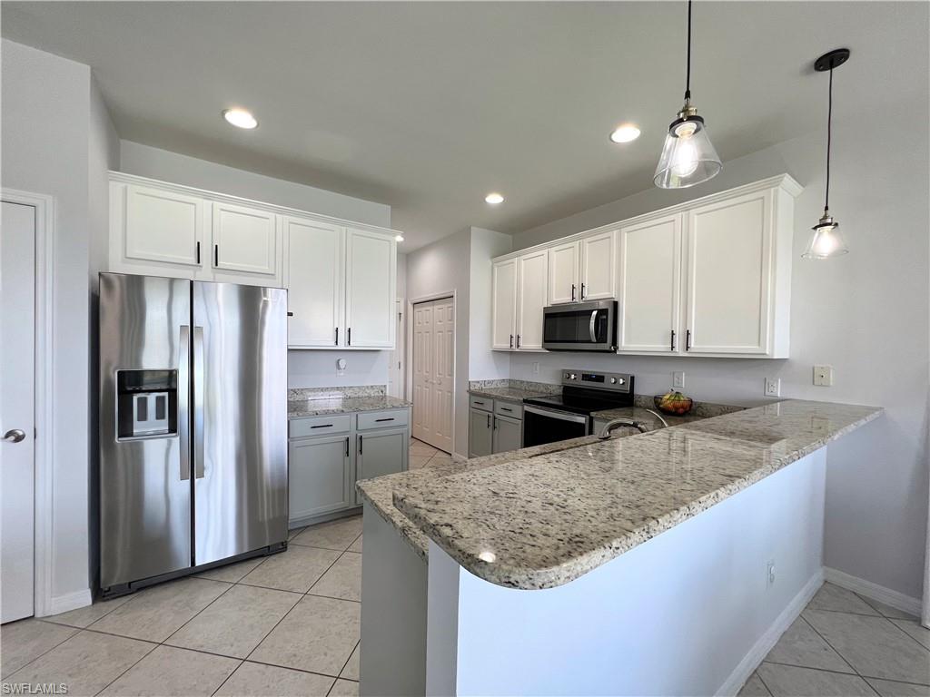 14776 Sutherland Avenue, Unit 416 Naples, FL 34119 - Photo 21 of 50 a kitchen with refrigerator and microwave