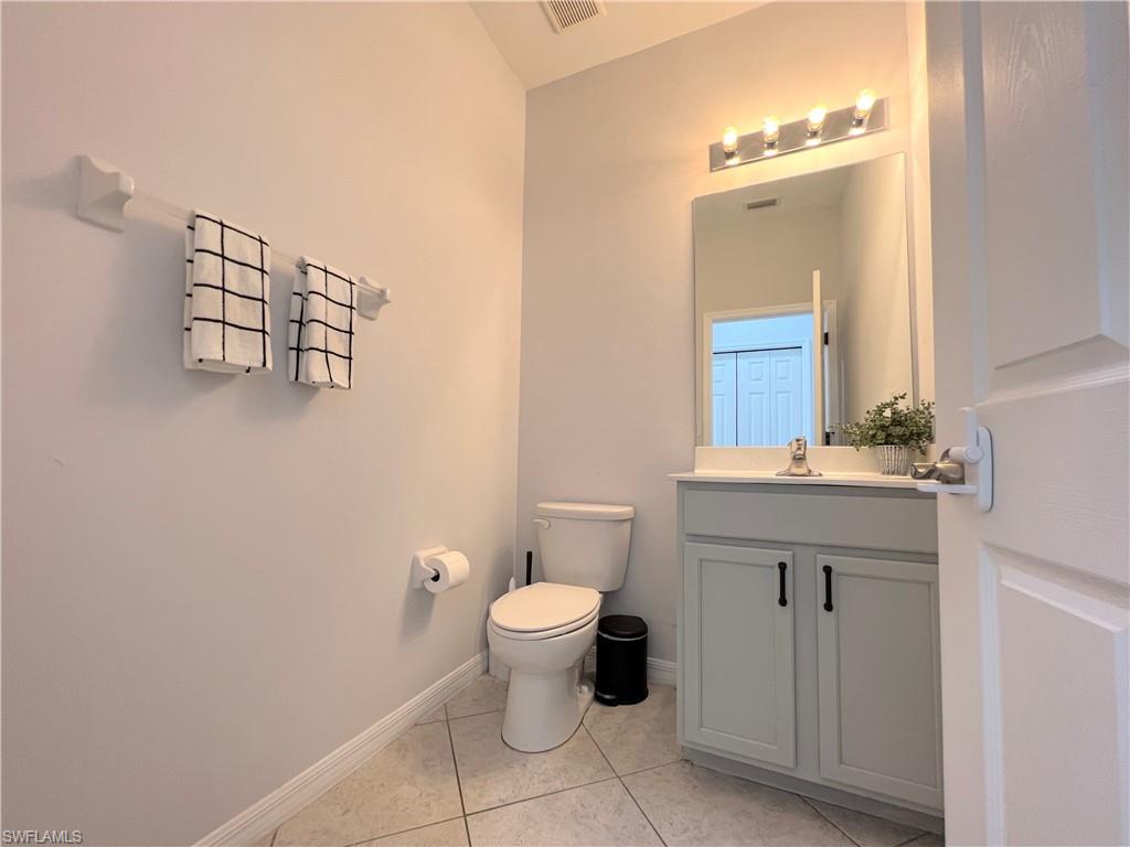14776 Sutherland Avenue, Unit 416 Naples, FL 34119 - Photo 23 of 50 a bathroom with a toilet sink and mirror