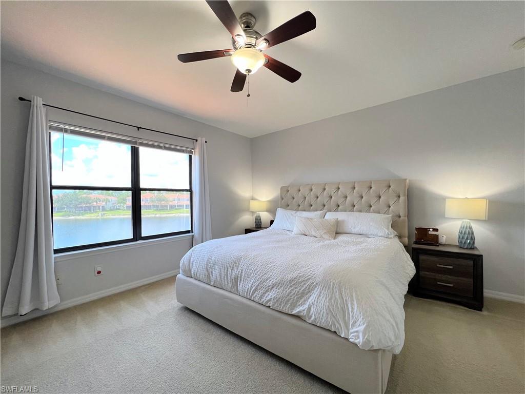 14776 Sutherland Avenue, Unit 416 Naples, FL 34119 - Photo 24 of 50 a bedroom with a bed and a large window