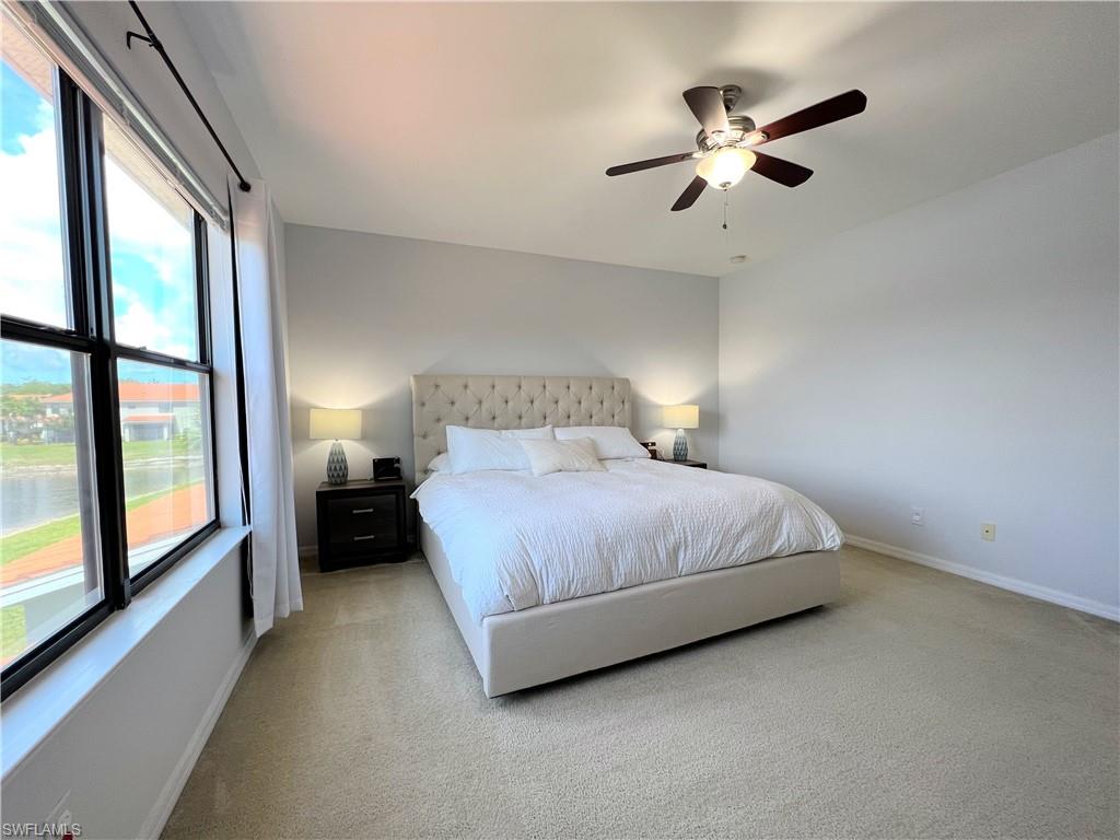 14776 Sutherland Avenue, Unit 416 Naples, FL 34119 - Photo 26 of 50 a bedroom with a bed and a large window