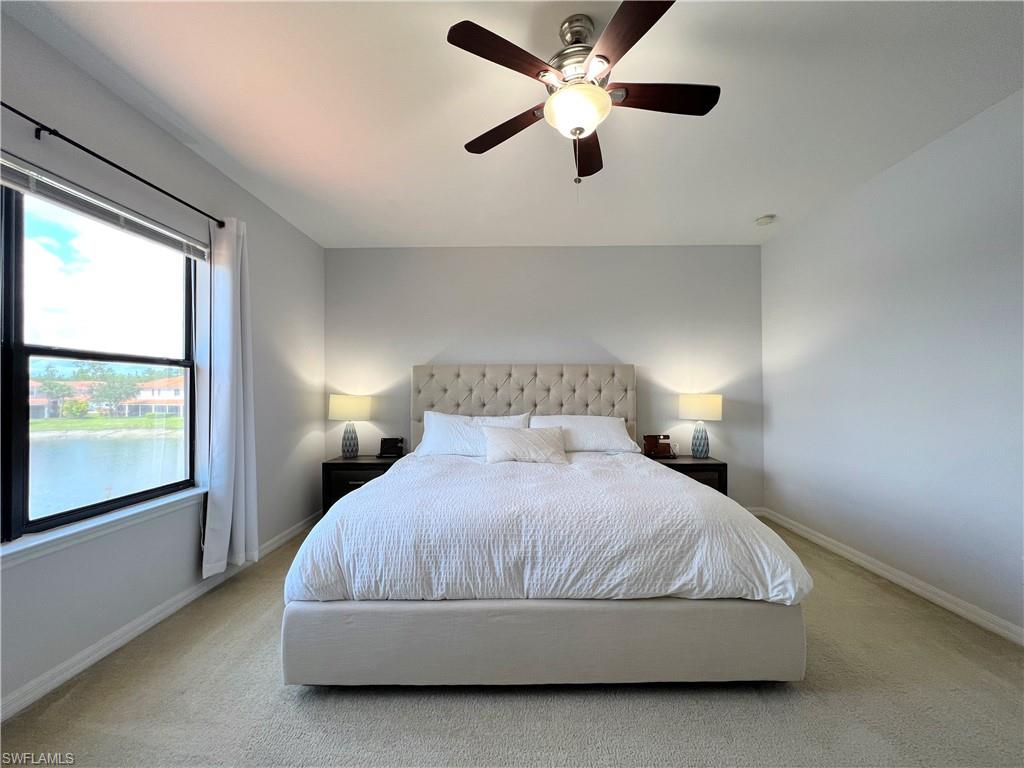 14776 Sutherland Avenue, Unit 416 Naples, FL 34119 - Photo 27 of 50 a bedroom with a large bed and a large window