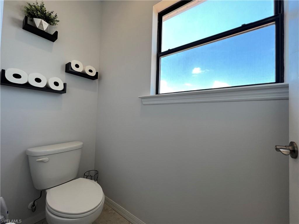 14776 Sutherland Avenue, Unit 416 Naples, FL 34119 - Photo 29 of 50 a white toilet sitting next to a window