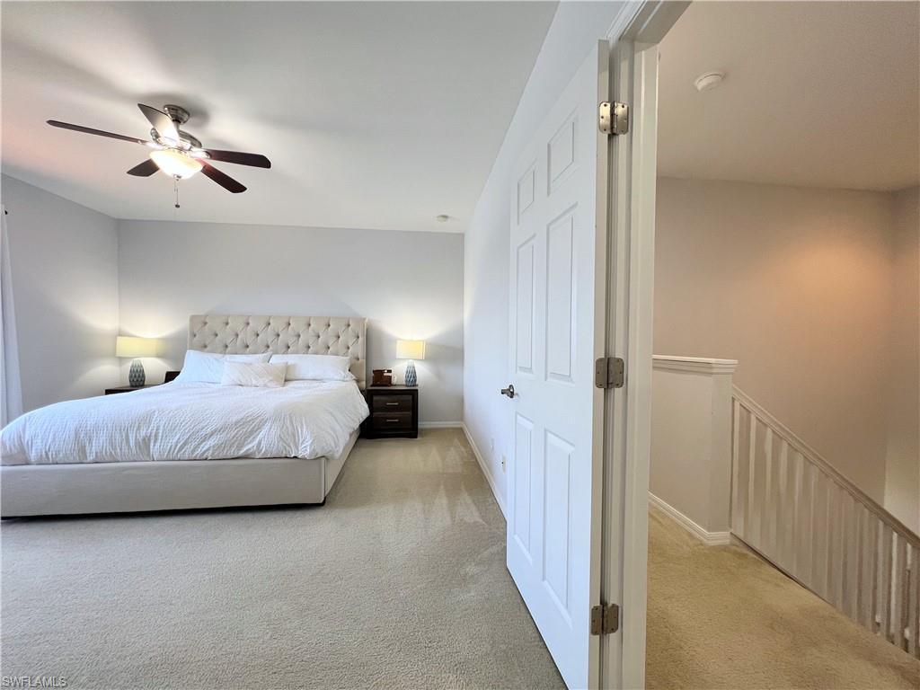 14776 Sutherland Avenue, Unit 416 Naples, FL 34119 - Photo 32 of 50 a bedroom with a bed and a chandelier